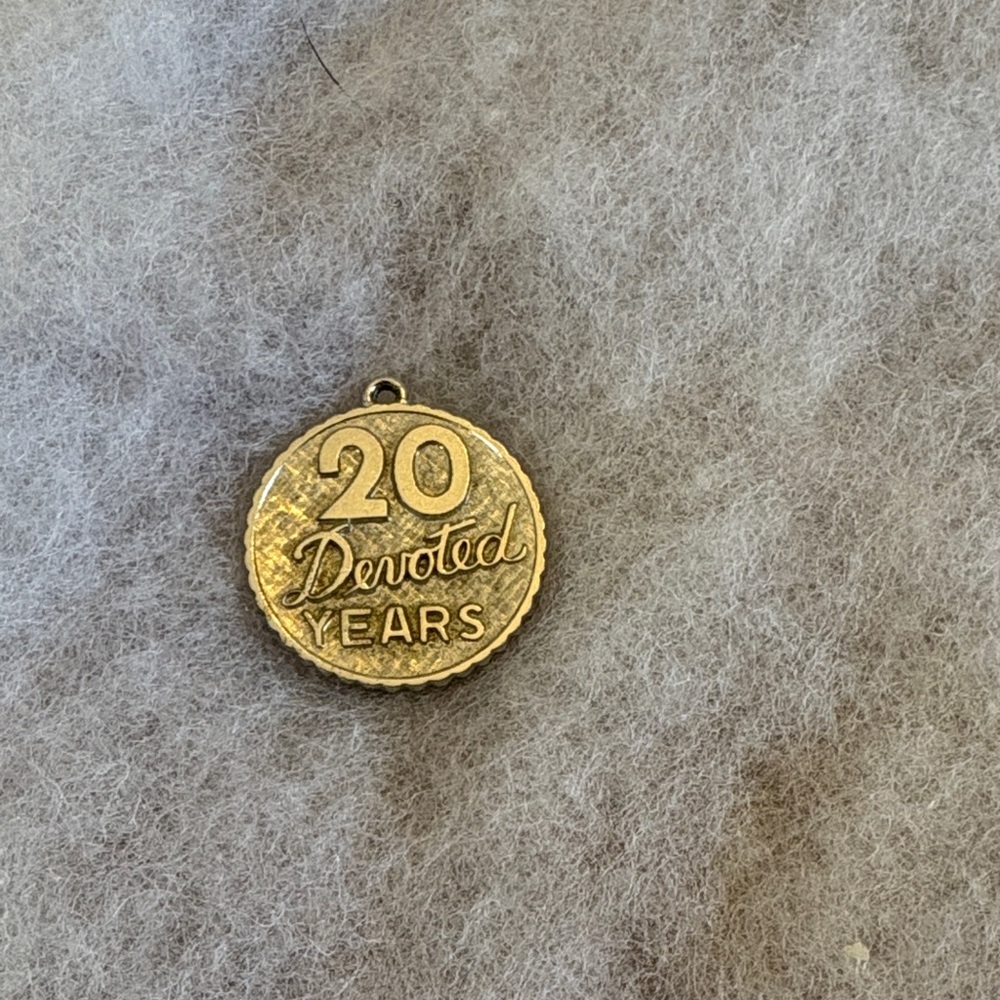 Round sterling silver charm. 20 years devoted. Can easily be engraved easily